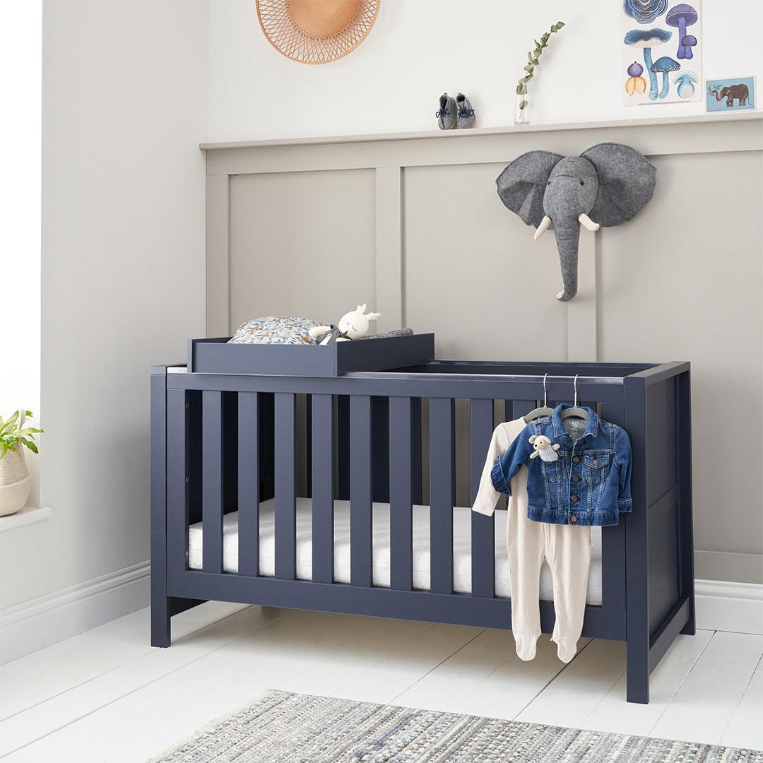 Cot bed with outlet changing top